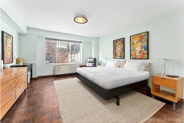 bedroom with radiator and dark parquet floors