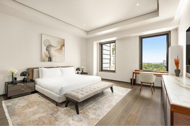 bedroom featuring a tray ceiling and dark hardwood / wood-style floors