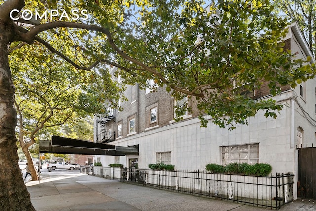 view of building exterior featuring fence