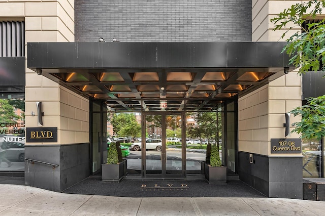 107-06 Queens Blvd Unit 7-G, New York City, NY 11375 - doorway to property featuring brick siding and a carport