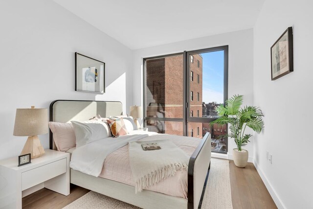 107-06 Queens Blvd Unit 7-G, New York City, NY 11375 - bedroom with wood finished floors, baseboards, and access to outside