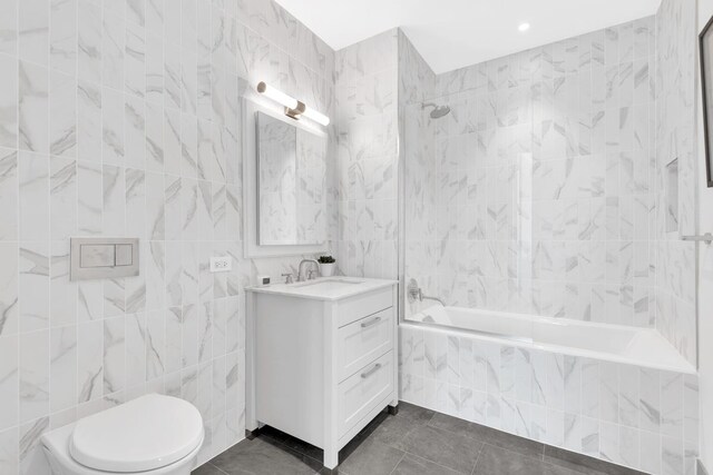 107-06 Queens Blvd Unit 7-G, New York City, NY 11375 - bathroom with tile walls, vanity, tiled shower / bath combo, toilet, and tile patterned flooring