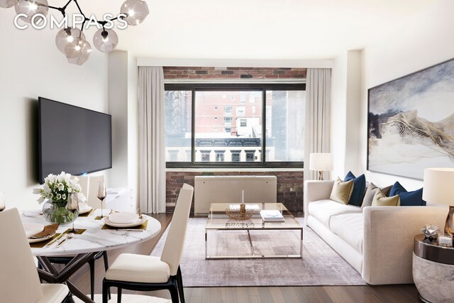 201 W 21st St Unit 7D, New York City, NY 10011 - living area featuring a chandelier, wood finished floors, and brick wall