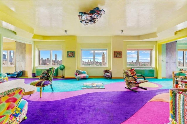 recreation room featuring plenty of natural light and carpet floors