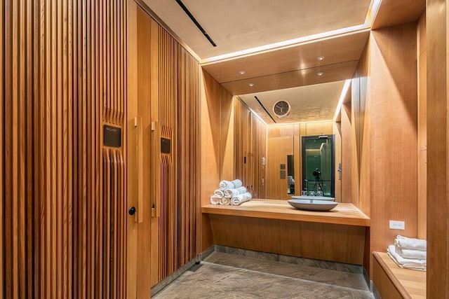 bathroom with wooden walls and vanity