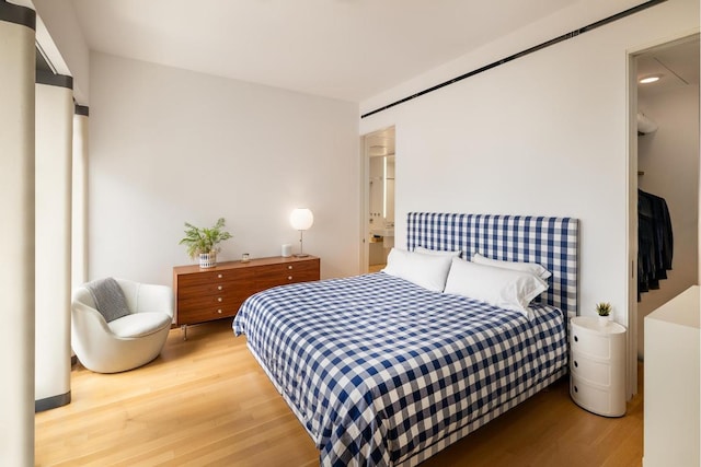 bedroom with light hardwood / wood-style floors