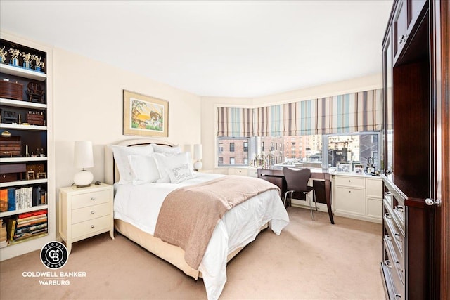 bedroom with a view of city and light colored carpet