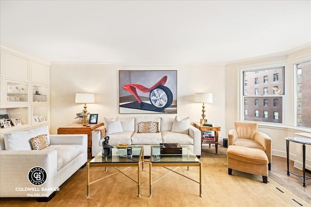 living area featuring ornamental molding and wood finished floors