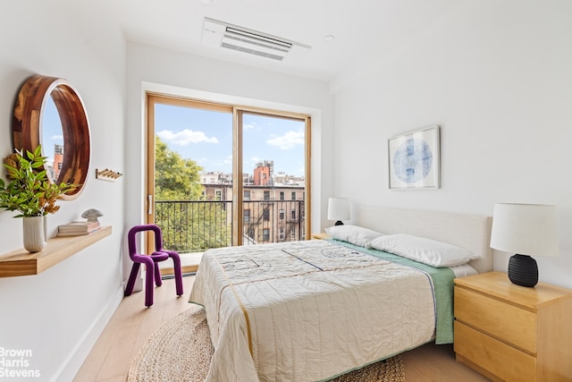 bedroom with access to outside and light hardwood / wood-style floors