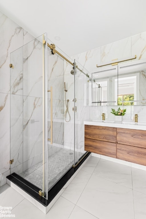 bathroom featuring vanity and a shower with door