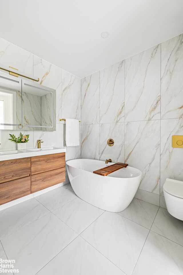 bathroom with toilet, vanity, and a tub to relax in