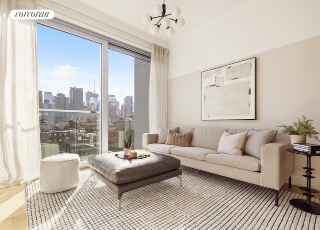 living room featuring a view of city, an inviting chandelier, and wood finished floors