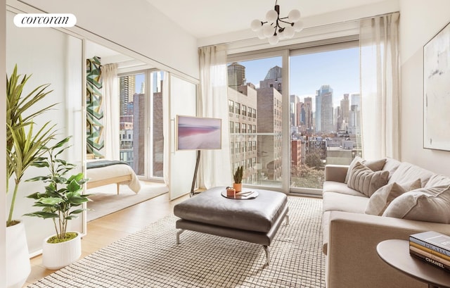 living room with a chandelier, visible vents, and wood finished floors