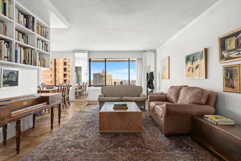 tiled living room with a city view, crown molding, and a textured ceiling