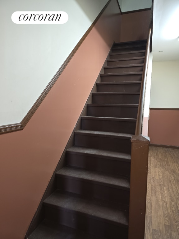 staircase with wood-type flooring