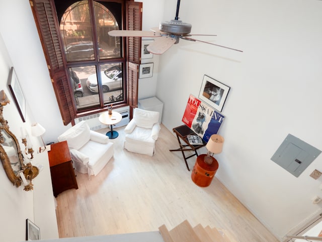 living area with ceiling fan and hardwood / wood-style flooring