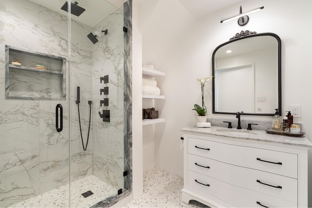 full bathroom with vanity and a marble finish shower