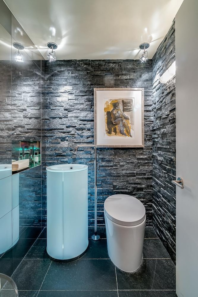 bathroom with toilet, vanity, and tile patterned floors