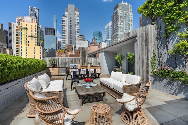 view of patio / terrace featuring an outdoor living space, a city view, and area for grilling