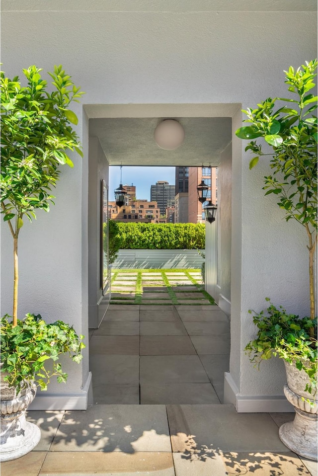 entrance to property with a balcony and stucco siding