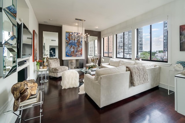 living area with a chandelier, dark wood-style flooring, plenty of natural light, and baseboards