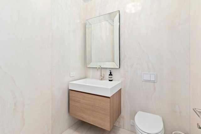 half bath with vanity and toilet