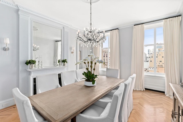 dining area featuring a chandelier, plenty of natural light, and baseboards