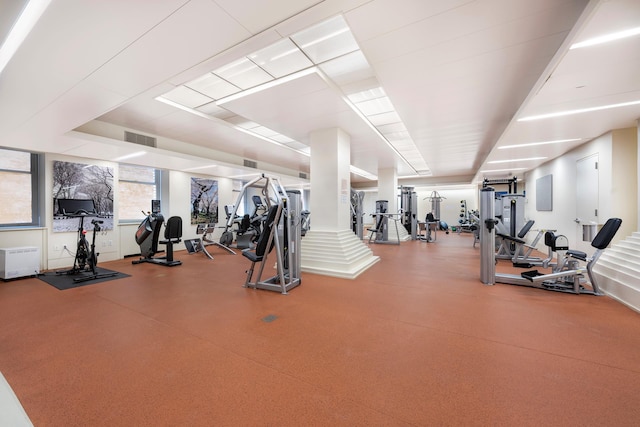 workout area with decorative columns and visible vents