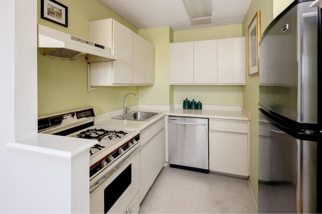 kitchen with stainless steel appliances, white cabinets, and sink