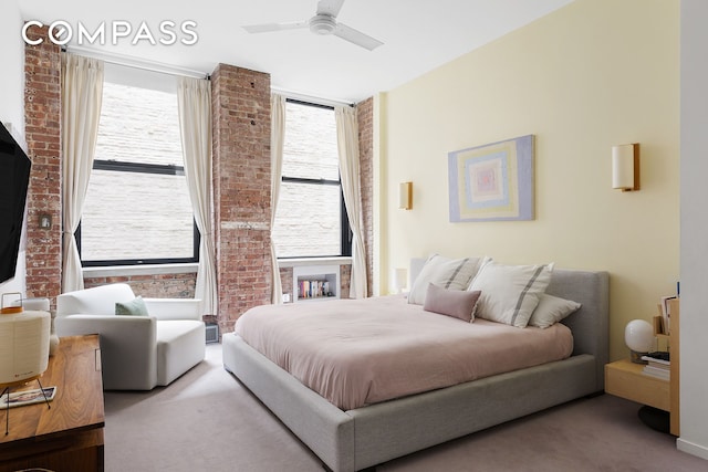 carpeted bedroom with multiple windows, brick wall, and ceiling fan