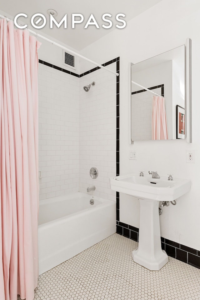 bathroom featuring tile patterned floors, visible vents, and shower / tub combo