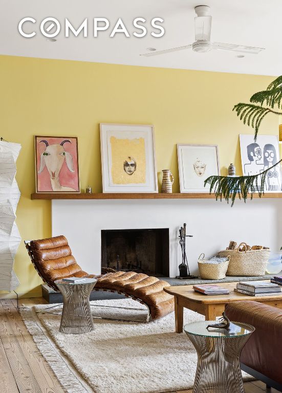 sitting room with ceiling fan and wood-type flooring