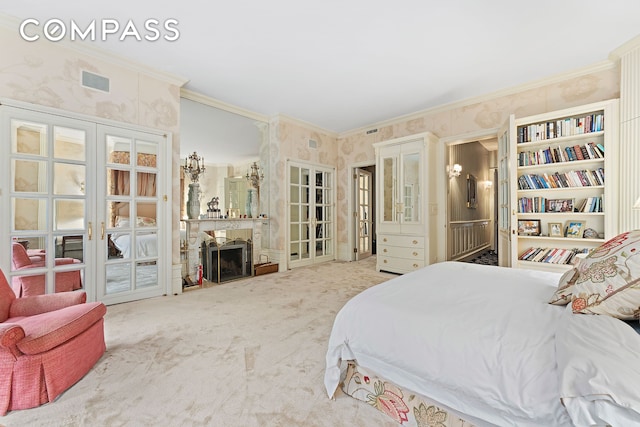 carpeted bedroom with ornamental molding, french doors, a fireplace, and wallpapered walls