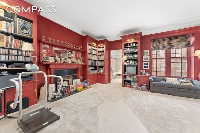interior space with built in features, carpet flooring, and a fireplace