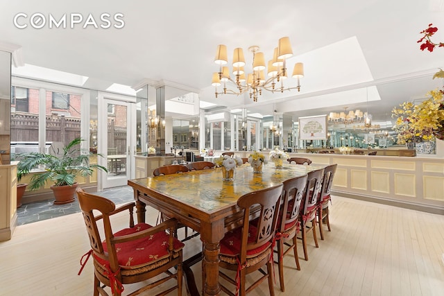 dining room featuring light wood-type flooring and a chandelier