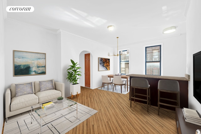 living room with a chandelier and crown molding