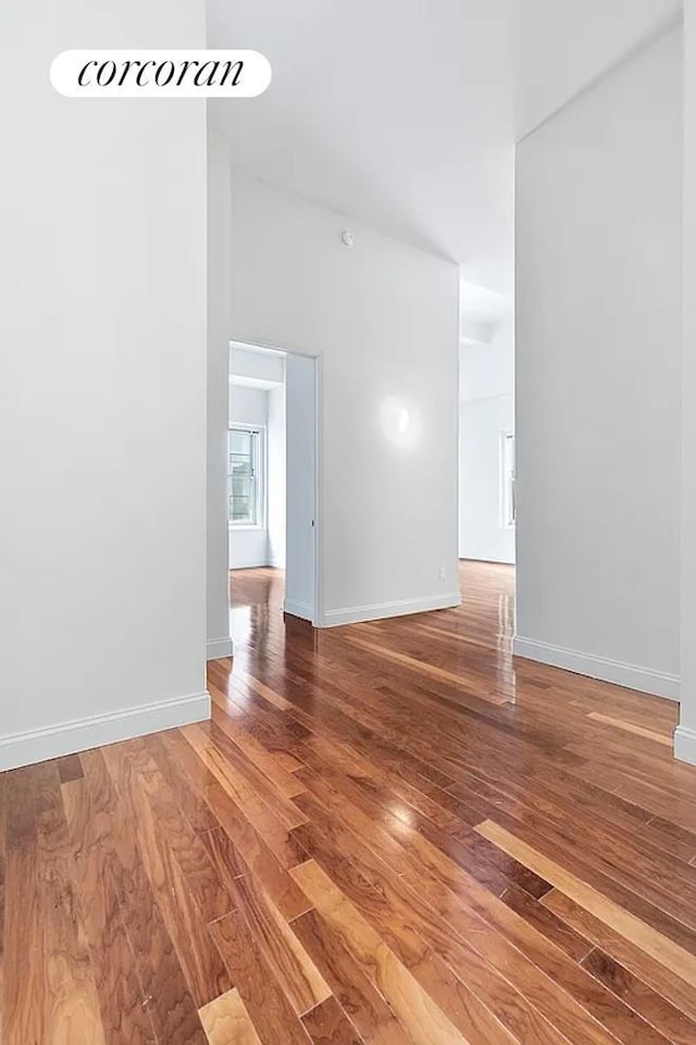 empty room featuring baseboards and wood finished floors