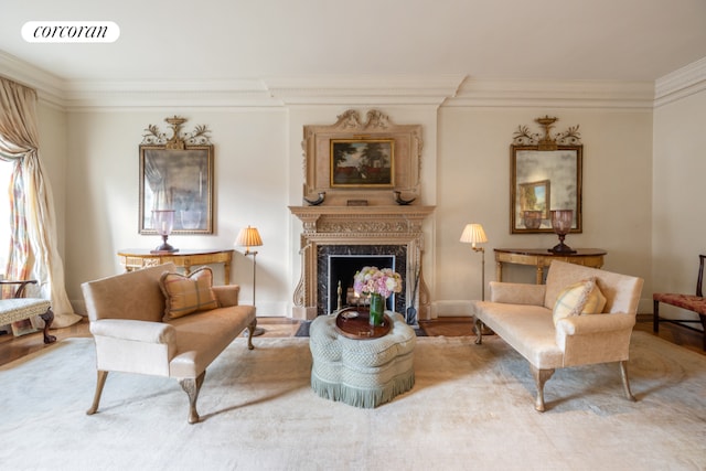 living area with crown molding and a fireplace