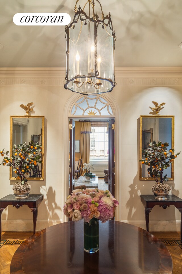 living area featuring built in features, a high end fireplace, and crown molding