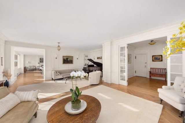 living room with light parquet flooring and crown molding