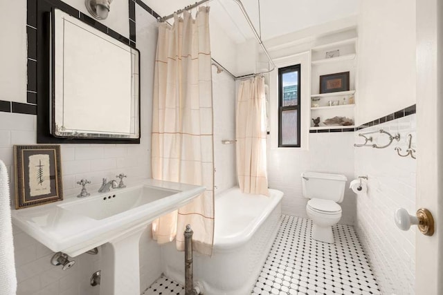 bathroom featuring toilet, tile walls, and shower / bath combination with curtain