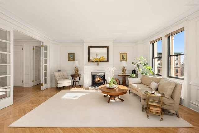 living room with light parquet floors and ornamental molding