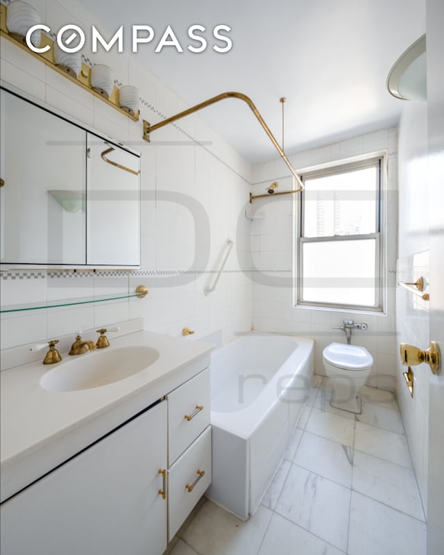 full bathroom with toilet, vanity, tile walls,  shower combination, and marble finish floor