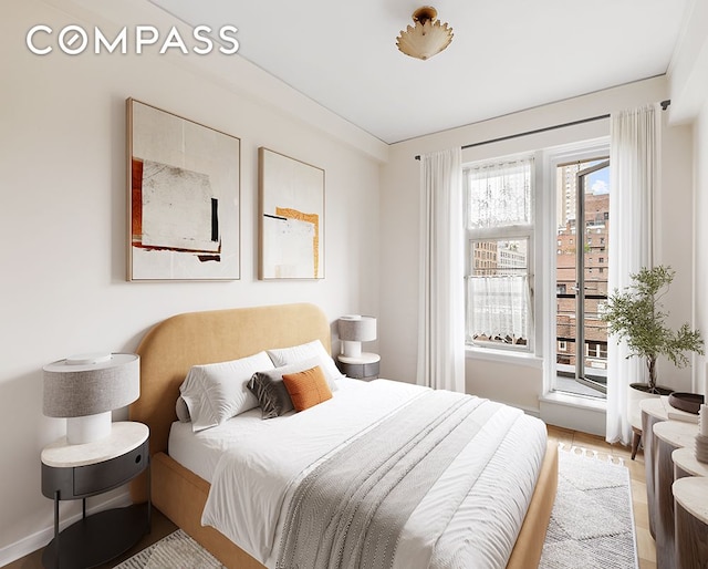 bedroom with light wood-style flooring and baseboards