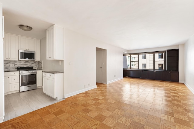85 Livingston St Unit 15L, New York City, NY 11201 - kitchen with appliances with stainless steel finishes, open floor plan, white cabinetry, and backsplash
