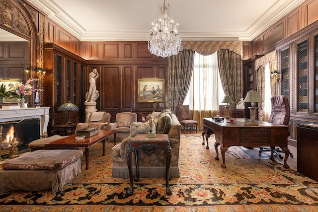 living area with a warm lit fireplace, ornamental molding, and an inviting chandelier