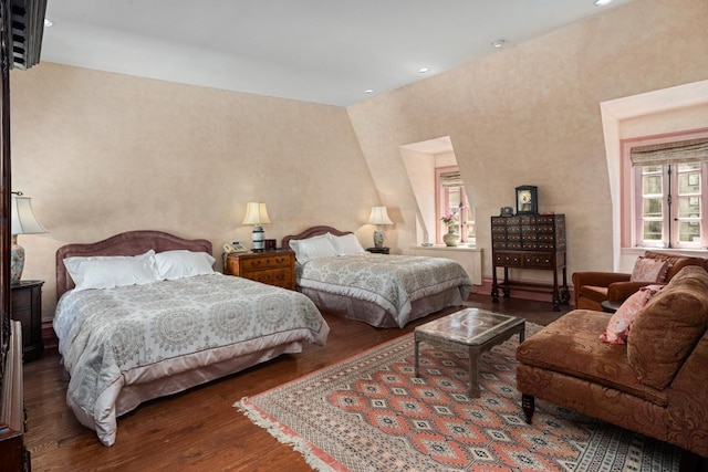 bedroom with dark hardwood / wood-style floors