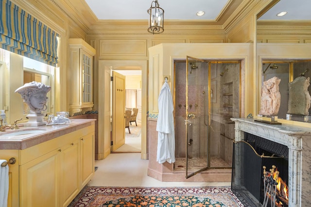 bathroom featuring ornamental molding, a stall shower, vanity, and a high end fireplace