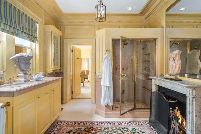 bathroom featuring a shower with door, crown molding, and vanity