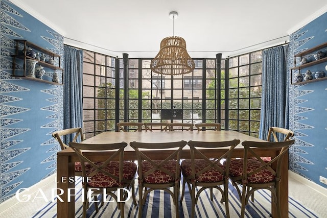 dining room featuring crown molding, a healthy amount of sunlight, and baseboards